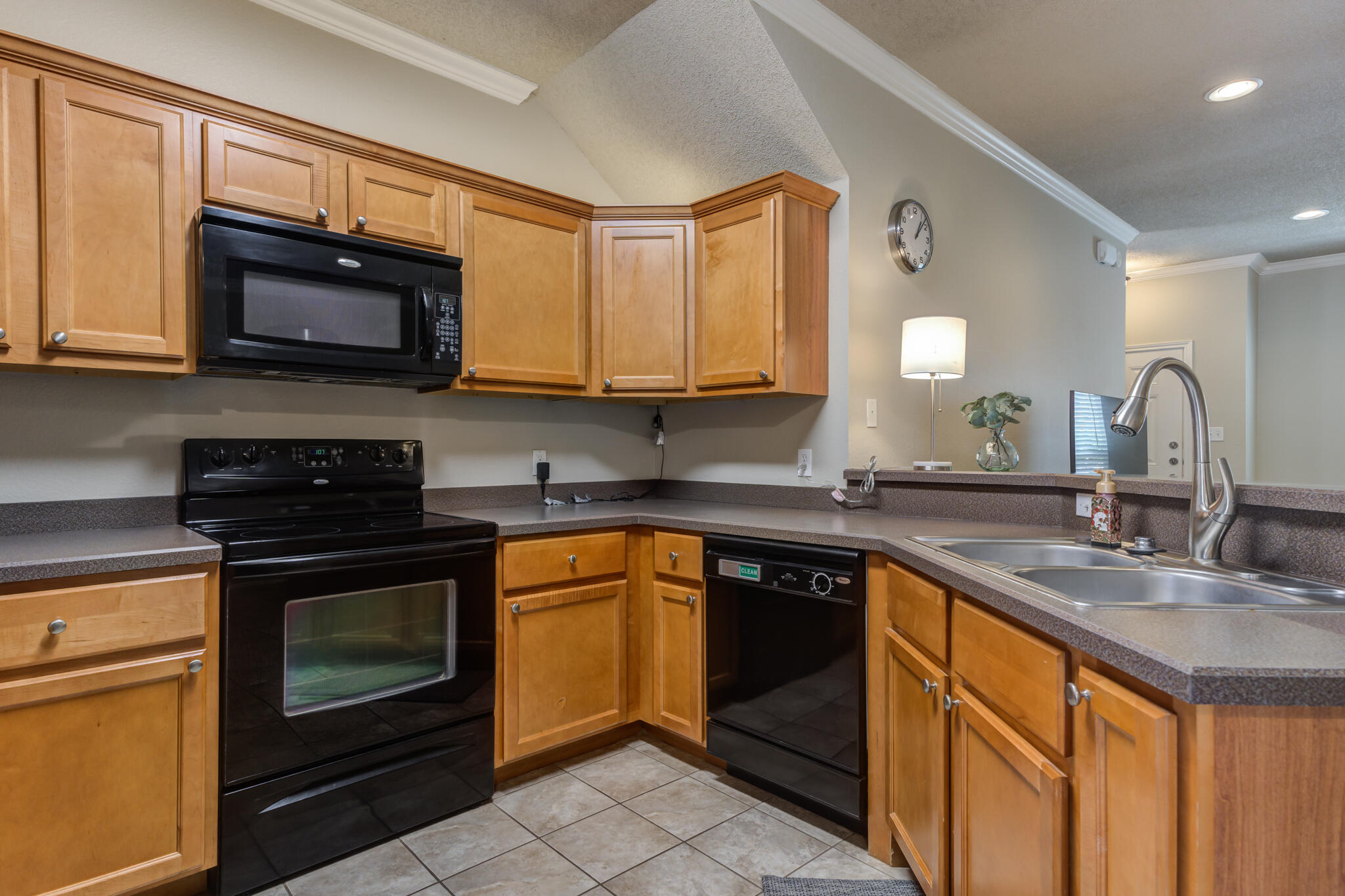 2108 Main Street, Unit 1 Lubbock, TX 79401 - Photo 12 of 29 a kitchen with stainless steel appliances granite countertop a sink stove and microwave