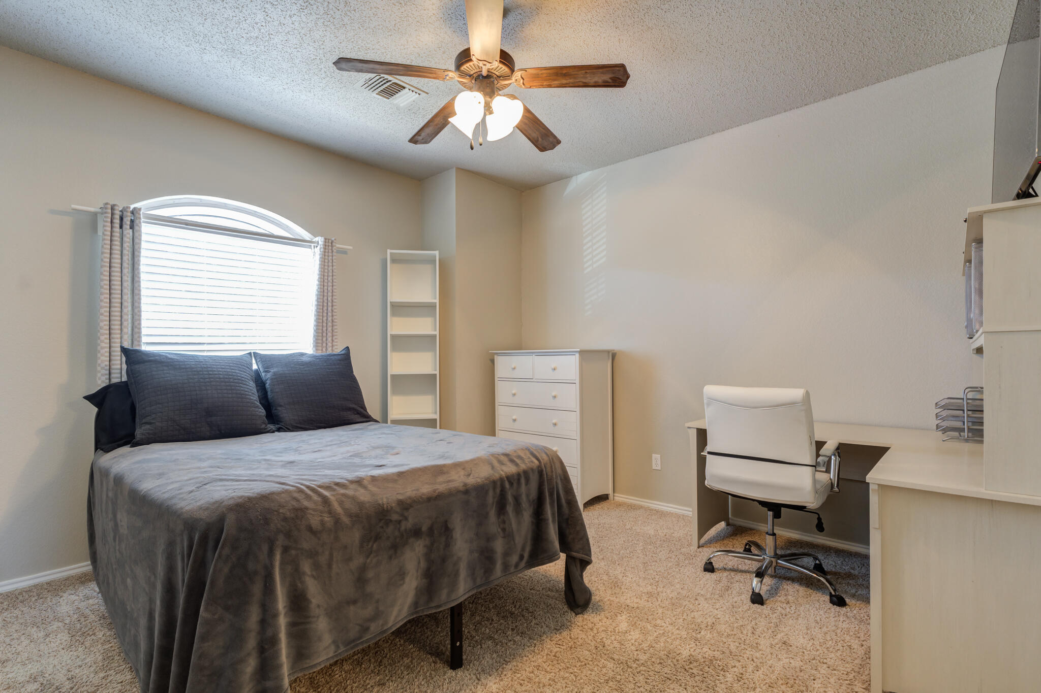 2108 Main Street, Unit 1 Lubbock, TX 79401 - Photo 20 of 29 a bedroom with a bed and a chandelier