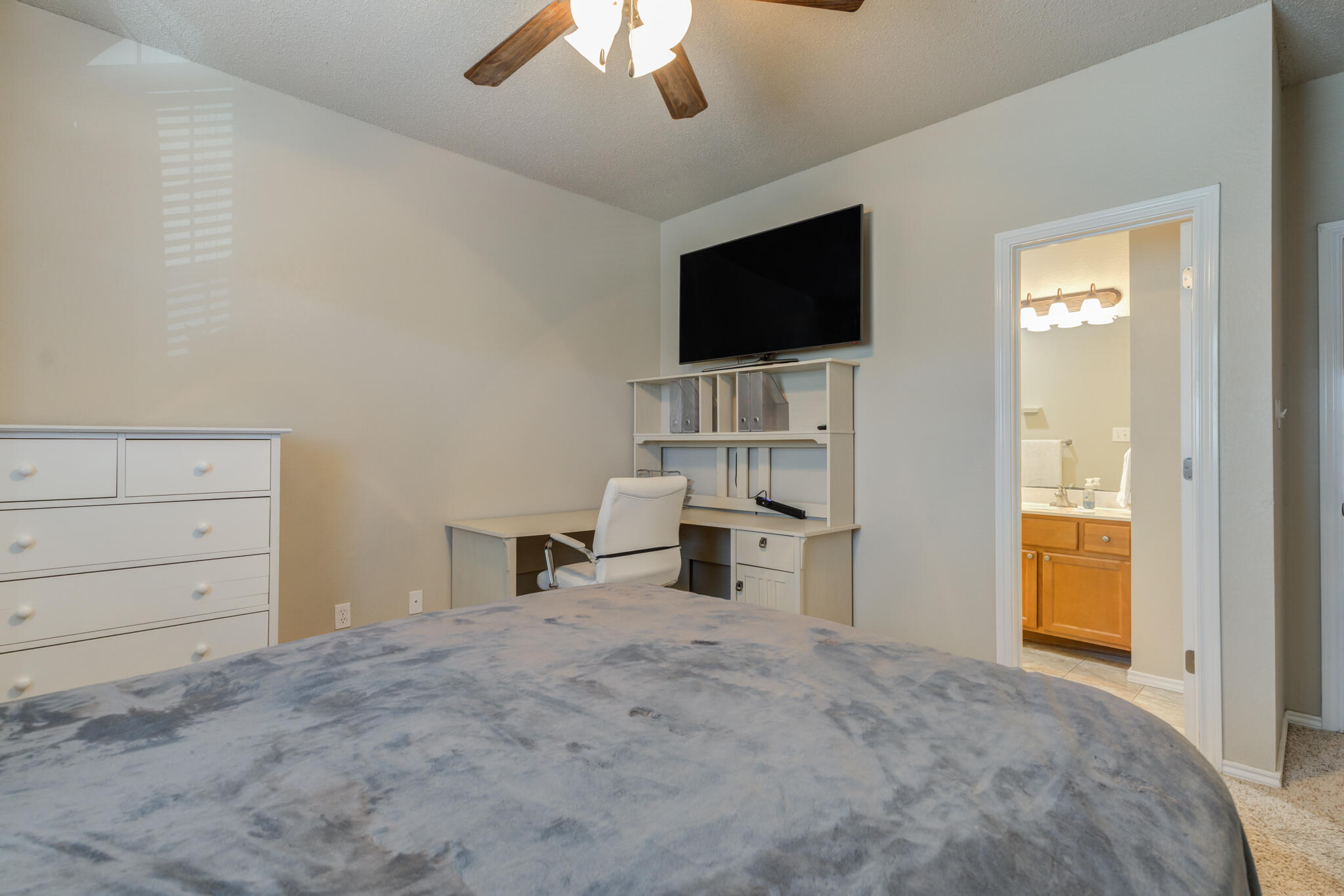 2108 Main Street, Unit 1 Lubbock, TX 79401 - Photo 21 of 29 a view of a livingroom with a flat screen tv wooden floor and a ceiling fan