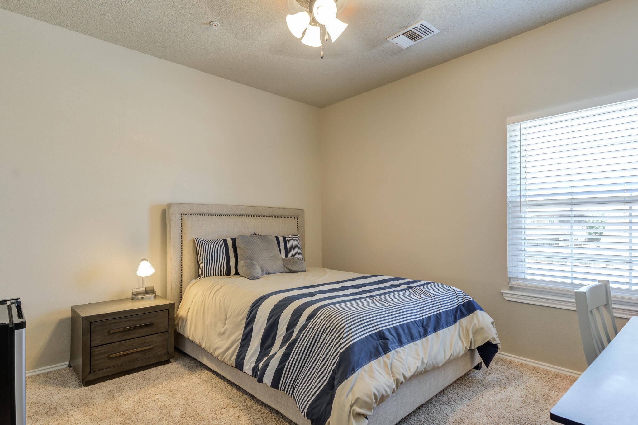 2108 Main Street, Unit 1 Lubbock, TX 79401 - Photo 25 of 29 a bedroom with a bed and a chandelier
