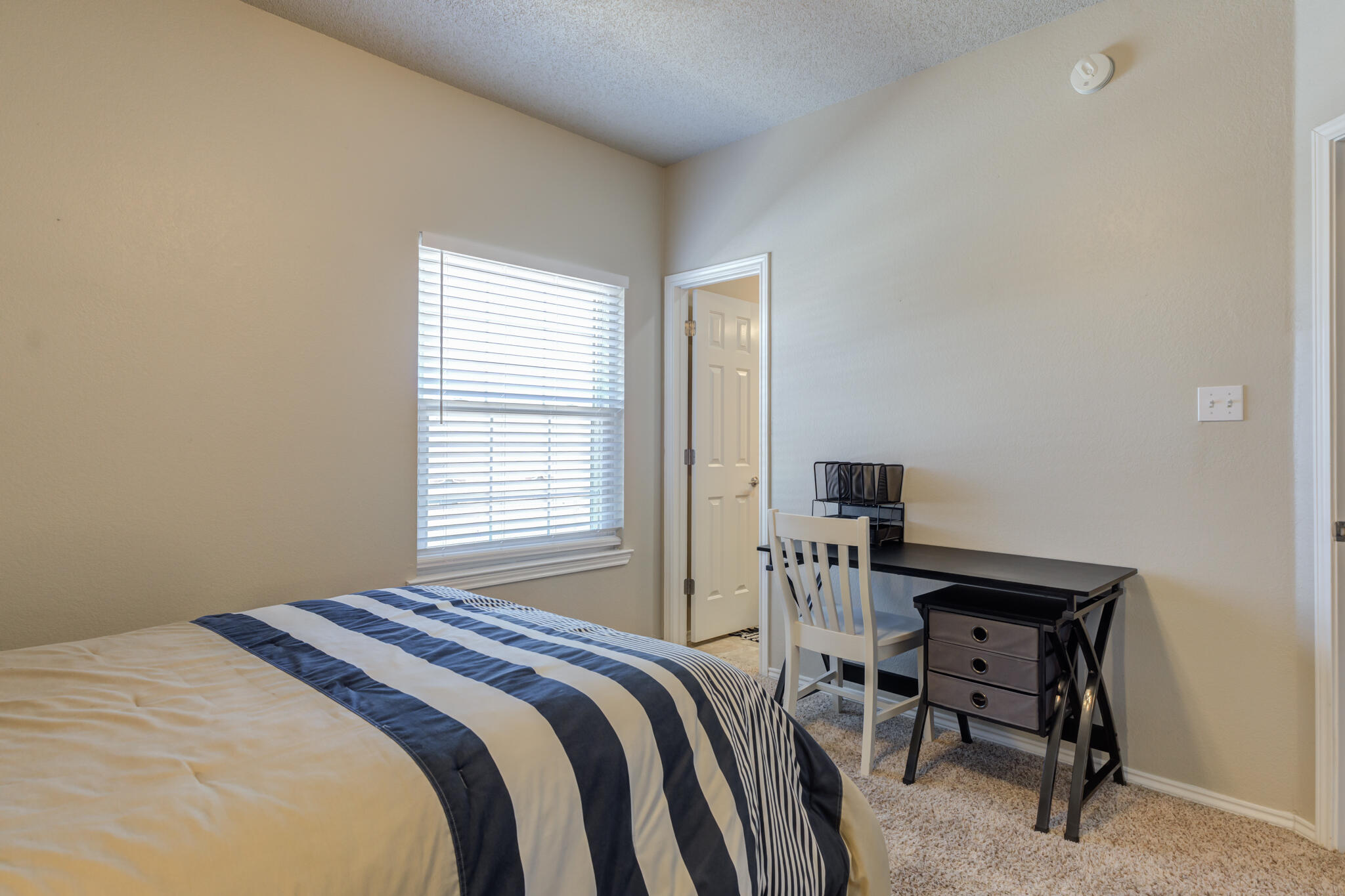 2108 Main Street, Unit 1 Lubbock, TX 79401 - Photo 26 of 29 a bedroom with a bed and a table