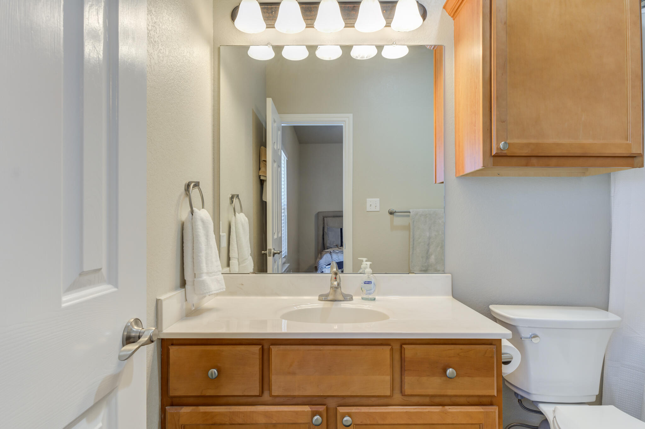 2108 Main Street, Unit 1 Lubbock, TX 79401 - Photo 27 of 29 a bathroom with a sink a toilet and a mirror