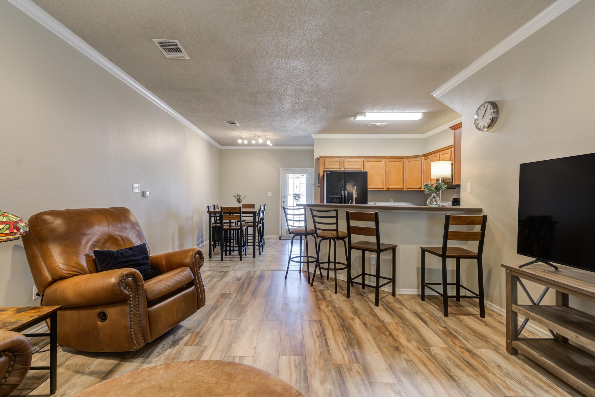 2108 Main Street, Unit 1 Lubbock, TX 79401 - Photo 6 of 29 a living room with furniture and a flat screen tv