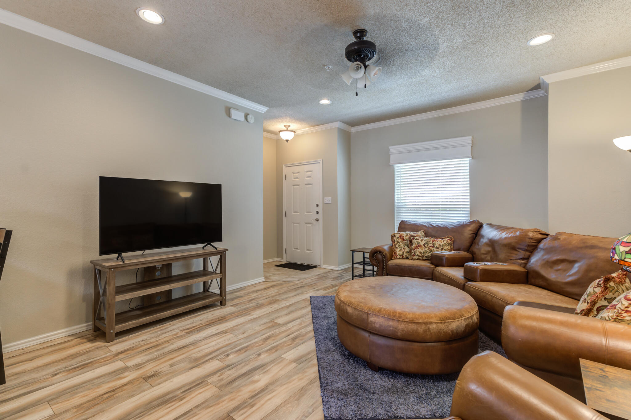 2108 Main Street, Unit 1 Lubbock, TX 79401 - Photo 7 of 29 a living room with furniture and a flat screen tv