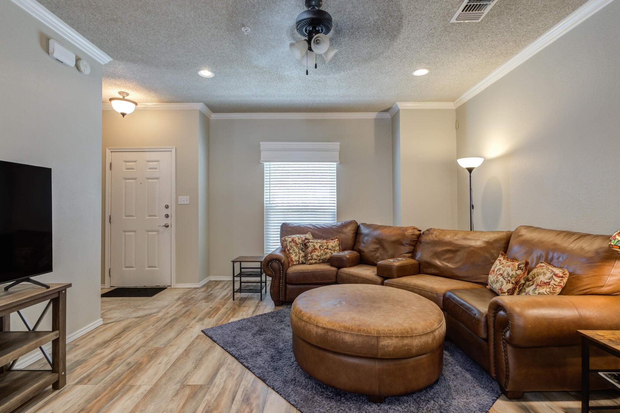 2108 Main Street, Unit 1 Lubbock, TX 79401 - Photo 8 of 29 a living room with furniture and a flat screen tv