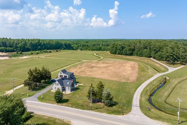 a view of a swimming pool with an outdoor seating and a garden