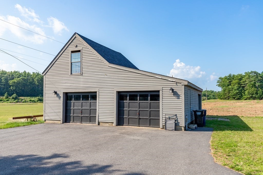 79 Wapping Road Kingston, MA 02364 - Photo 15 of 19 a front view of a house with a yard and garage