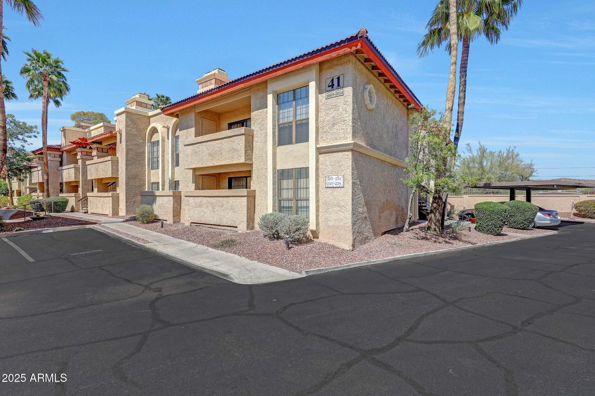 10410 North Cave Creek Road, Unit 1011 Phoenix, AZ 85020 - Photo 38 of 54 a view of a house with backyard and a garage
