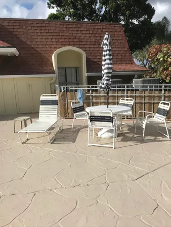 a view of a patio with a table and chairs