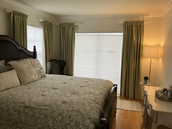 a bedroom with a bed and a dresser with mirror