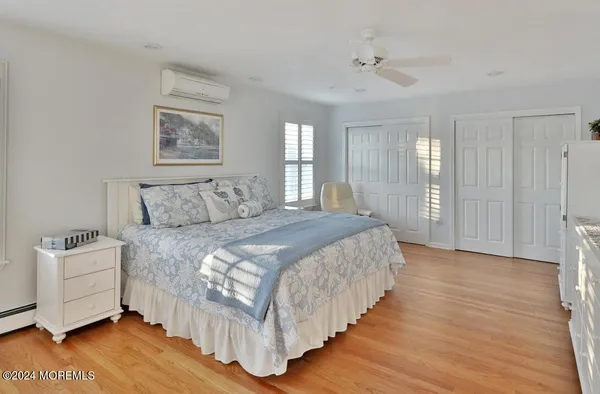 a bedroom with bed and wooden floor