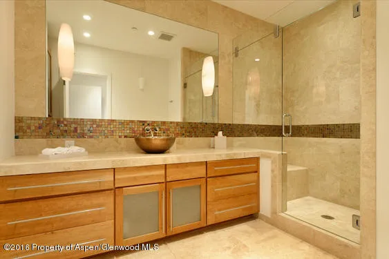 a bathroom with a shower sink and mirror