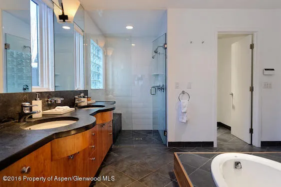 a bathroom with a sink a mirror and a bathtub
