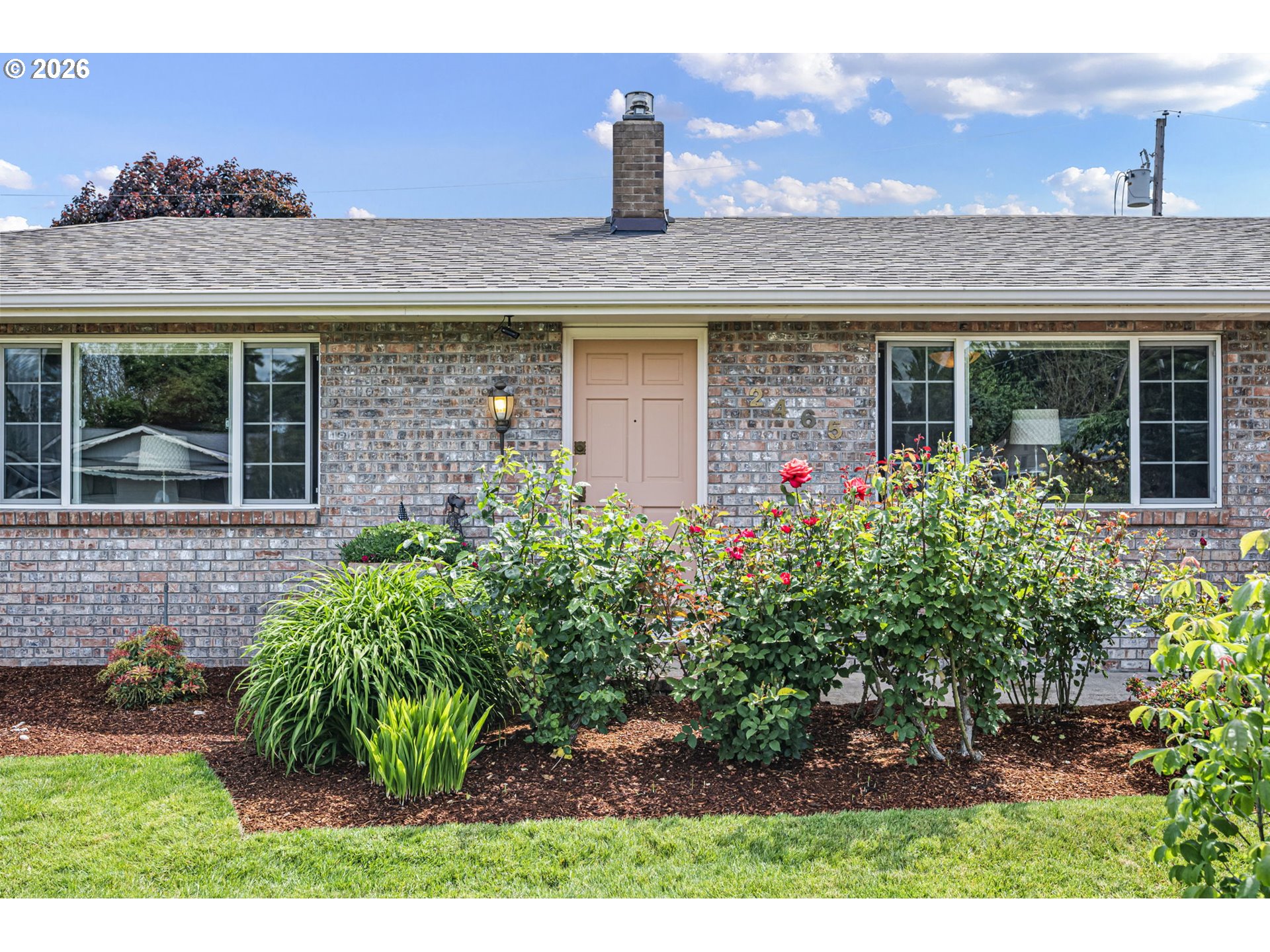 2465 17th Street Springfield, OR 97477 - Photo 5 of 47 a front view of a house with a garden