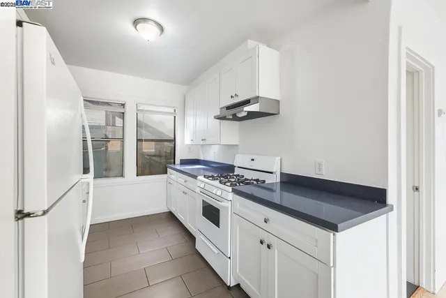 a kitchen with a stove and a refrigerator