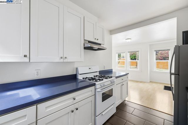 a kitchen with stainless steel appliances white cabinets and stove
