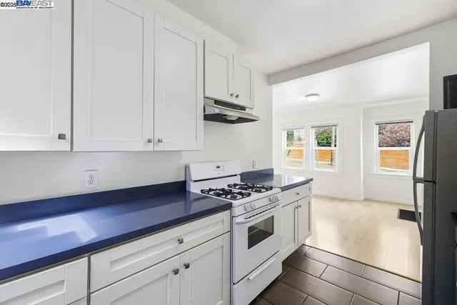 a kitchen with stainless steel appliances white cabinets and stove
