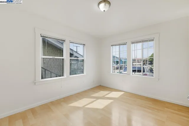 a view of a room with wooden floor and window