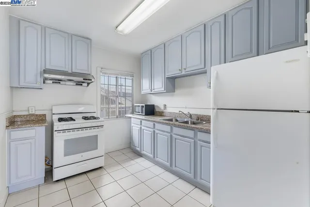 a bathroom with a toilet sink vanity and mirror