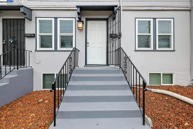 a view of stairs and with wooden floor and a front door