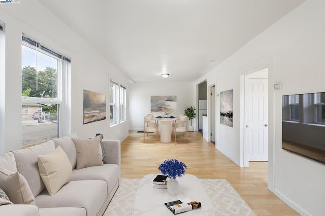 a living room with furniture fireplace and a large window