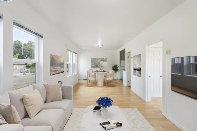 a living room with furniture fireplace and a large window