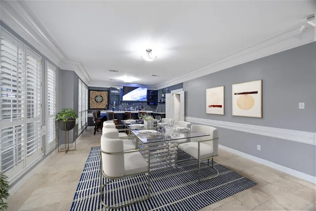 a living room with furniture a fireplace and large windows