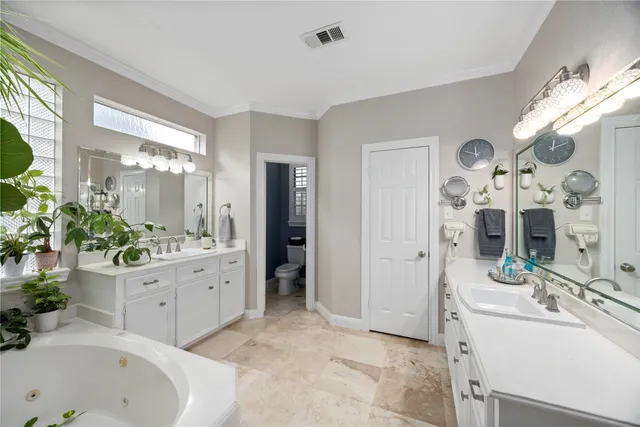 a spacious bathroom with a double vanity sink and a mirror