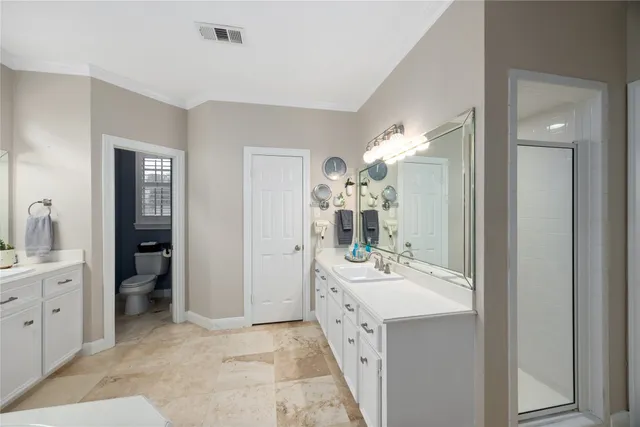 a white bath tub sitting next to a white sink and glass door