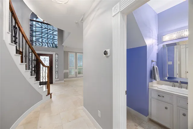 a bathroom with a sink vanity mirror and toilet
