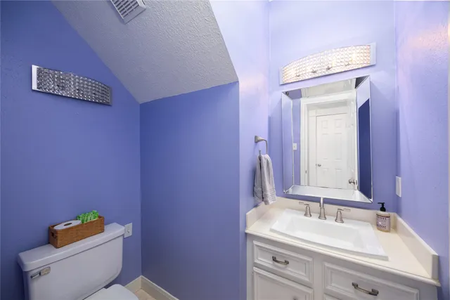 a view of staircase with railing and white walls