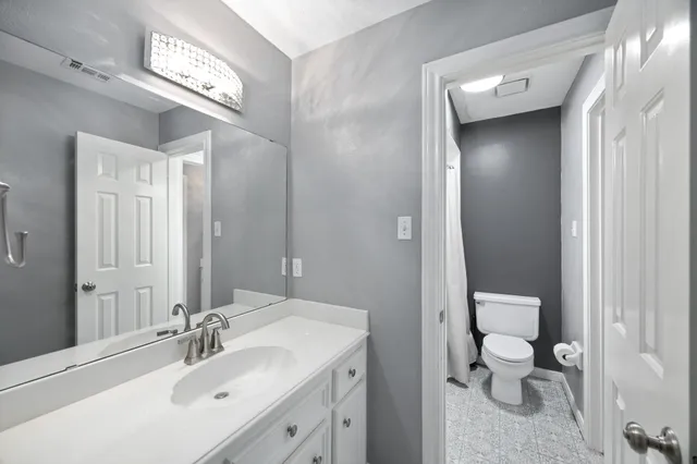 a bedroom with furniture a bed and a flat screen tv