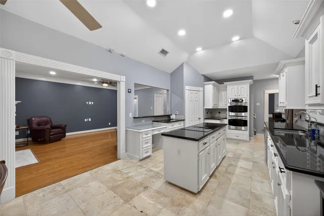 a large white kitchen with lots of counter top space