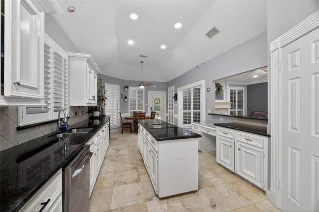 a kitchen with stainless steel appliances and cabinets