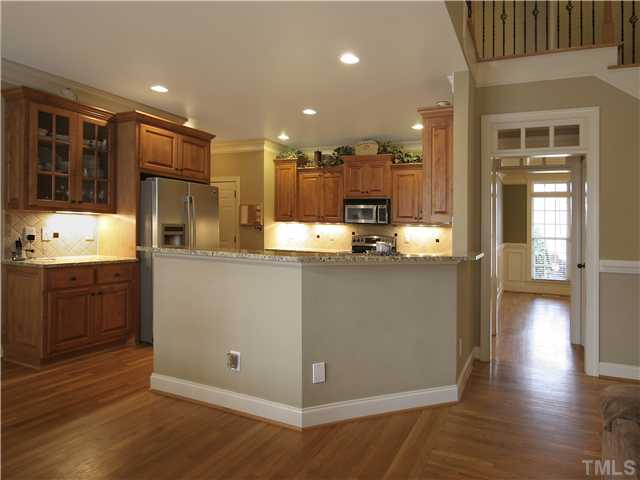 1200 Verde Farm Road Raleigh, NC 27603 - Photo 11 of 25 Bar-height seating area is great for homework, entertaining, or your more informal meals. Note the recessed lighting and the glass-front cabinets.