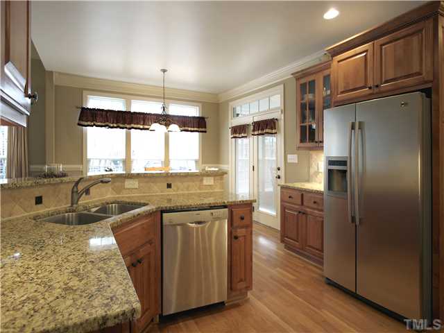 1200 Verde Farm Road Raleigh, NC 27603 - Photo 12 of 25 Kitchen is open to breakfast area and features stainless steel undermount sink, brushed nickel plumbing fixtures, and recessed lighting.