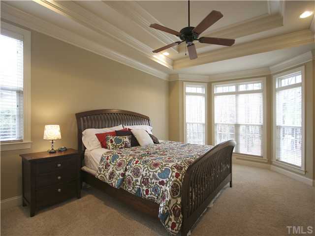 1200 Verde Farm Road Raleigh, NC 27603 - Photo 14 of 25 Master bedroom is spacious and features double trey ceiling, bay window, frieze carpet, recessed lighting, and ceiling fan.