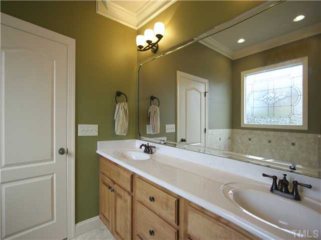 1200 Verde Farm Road Raleigh, NC 27603 - Photo 16 of 25 Master bath has dual-sink cultured marble vanity. Oil-rubbed-bronze fixtures. Tile floor. Separate toilet enclosure.