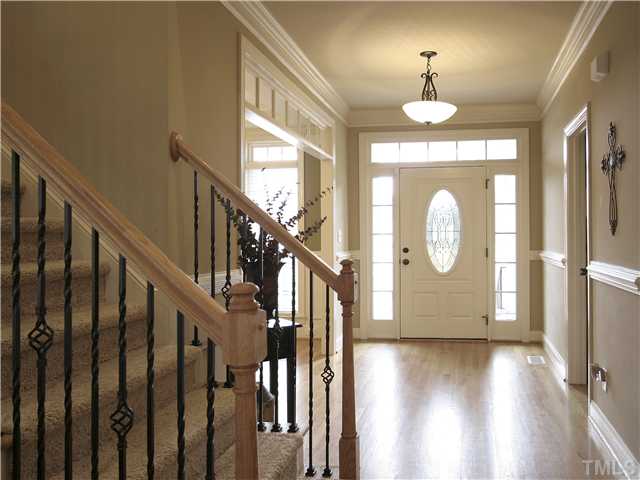 1200 Verde Farm Road Raleigh, NC 27603 - Photo 4 of 25 Gracious foyer greets you and your guests. Gleaming hardwood floor. Front door has sidelights, transom and oval leaded-glass window. Crown molding and chair rail complete the classic look.