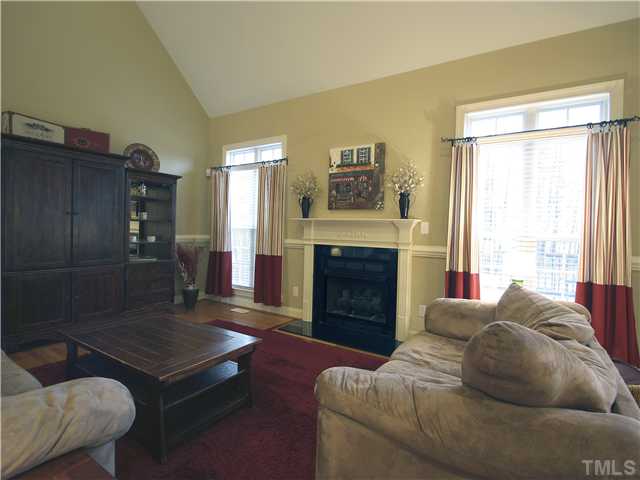 1200 Verde Farm Road Raleigh, NC 27603 - Photo 7 of 25 Family room features cozy gas-log fireplace with marble surround and detailed mantel. Two double windows bring in lots of natural light.