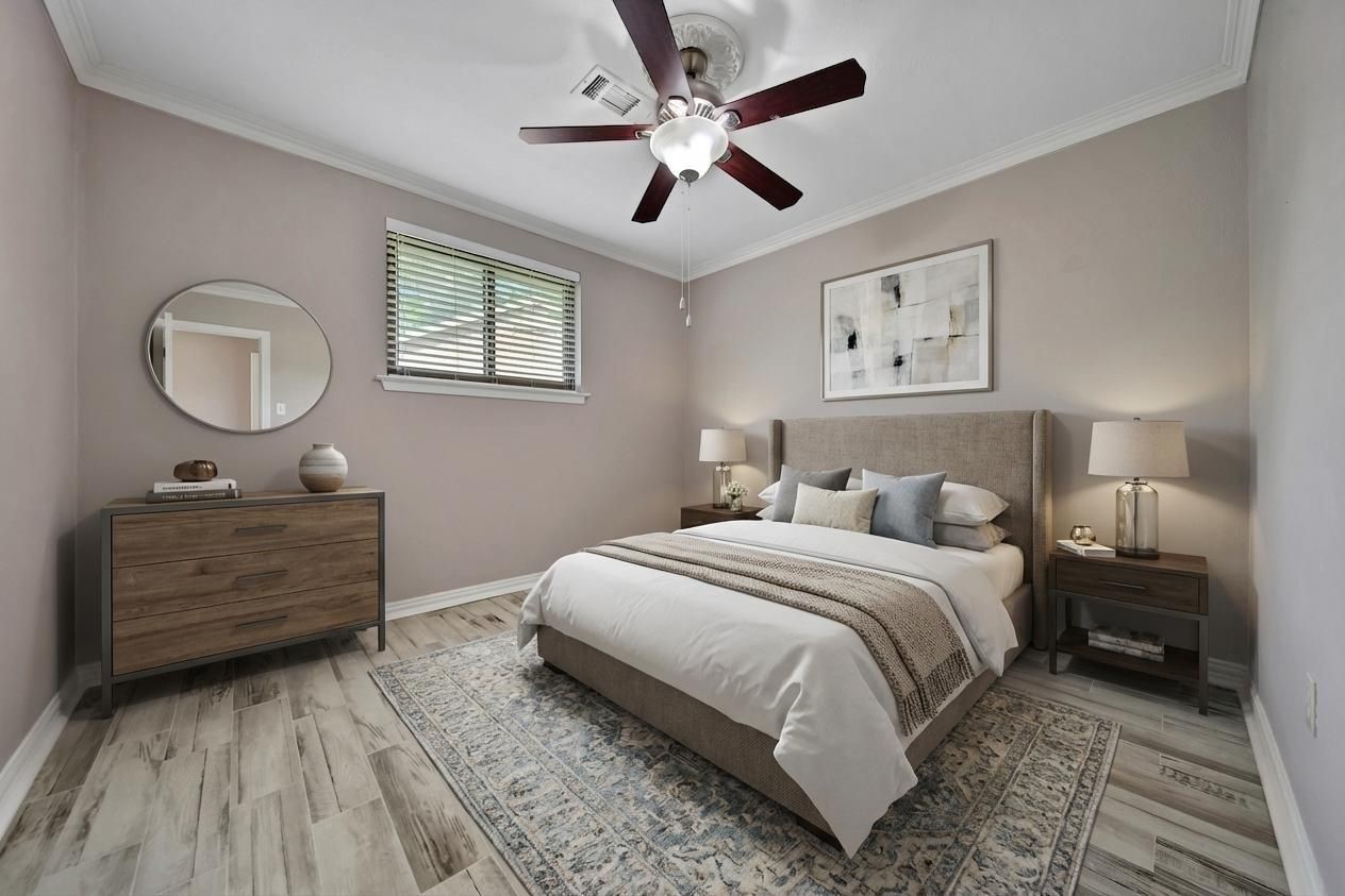 2006 Mermaid Lane Houston, TX 77062 - Photo 23 of 35 a bedroom with a bed and a chandelier