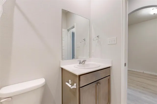 an empty room with a window and a ceiling fan