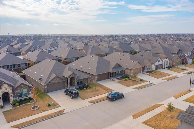 an aerial view of residential houses with outdoor space