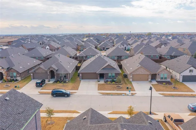 an aerial view of residential houses with outdoor space