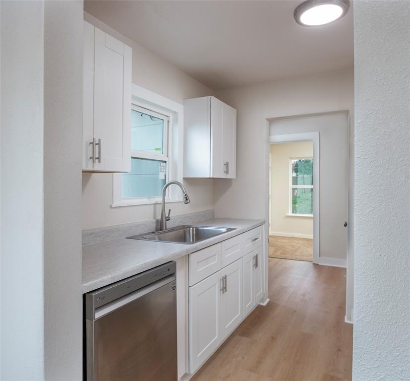 628 South Westmoreland Road Dallas, TX 75211 - Photo 6 of 19 a kitchen with stainless steel appliances granite countertop a sink stove and cabinets