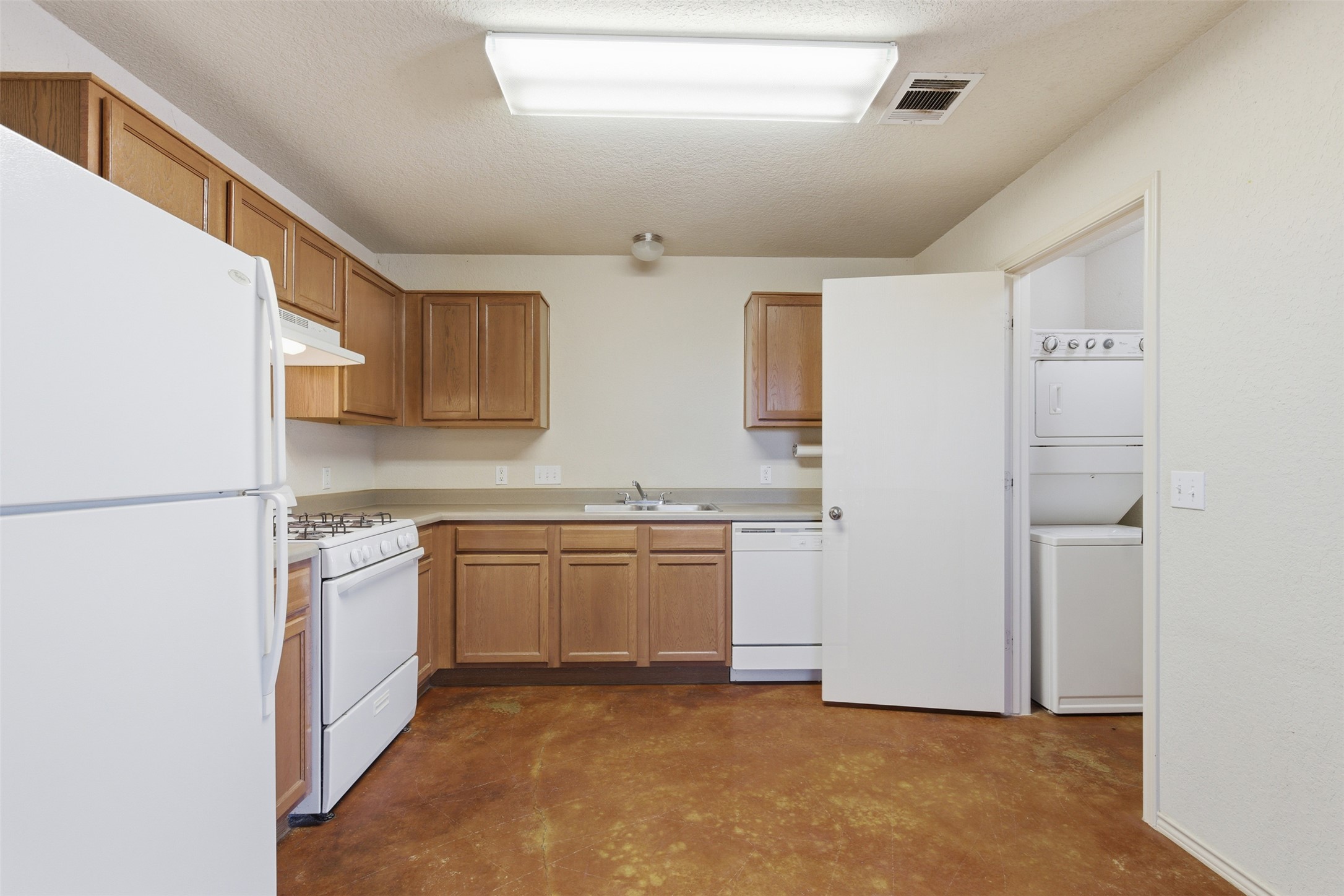 4529 Secure Lane, Unit 31 Austin, TX 78725 - Photo 11 of 38 a kitchen with stainless steel appliances granite countertop a refrigerator and a stove top oven