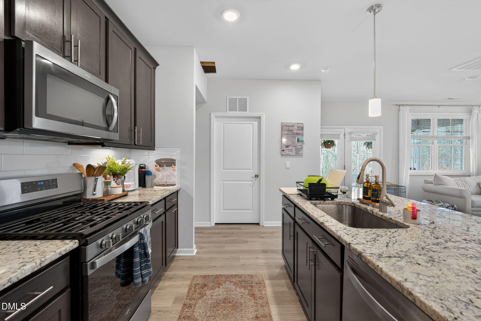 1519 Nichols Crk Road Durham, NC 27703 - Photo 14 of 22 a kitchen with stainless steel appliances granite countertop a sink stove and cabinets