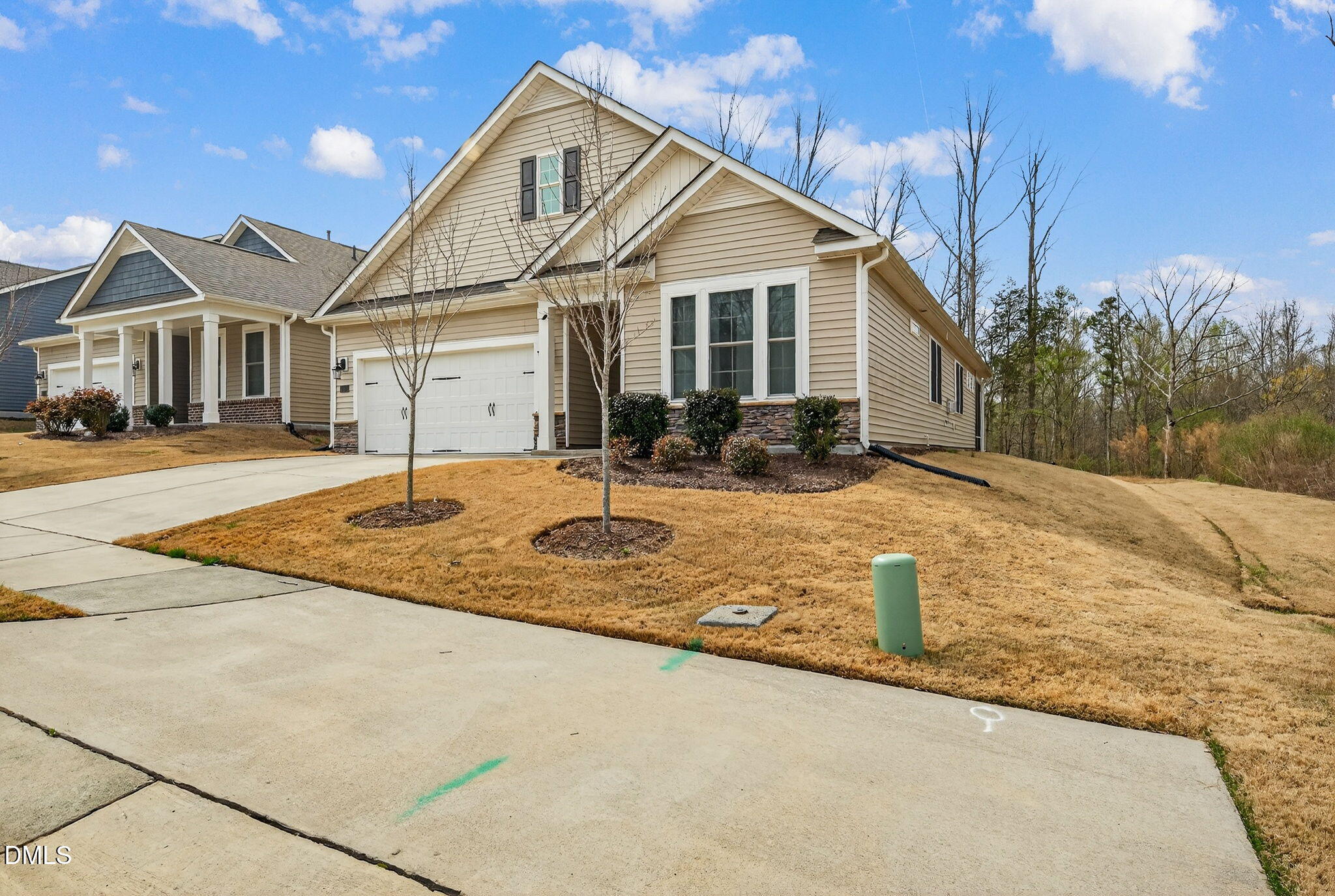 1519 Nichols Crk Road Durham, NC 27703 - Photo 2 of 22 a front view of a house with a yard covered with snow and trees