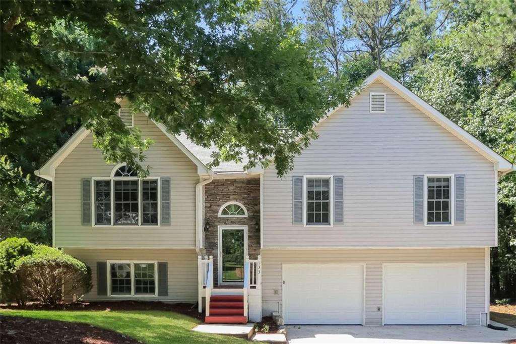 a front view of house with yard and green space