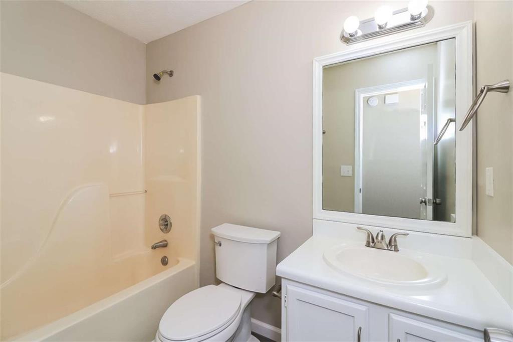 133 Johnstons Way Dallas, GA 30132 - Photo 13 of 15 a bathroom with a sink a toilet and shower